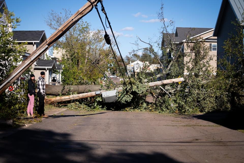 A tree lies on the power line it took out in the middle of a Charlottetown street immediately after Fiona, in September of 2022.