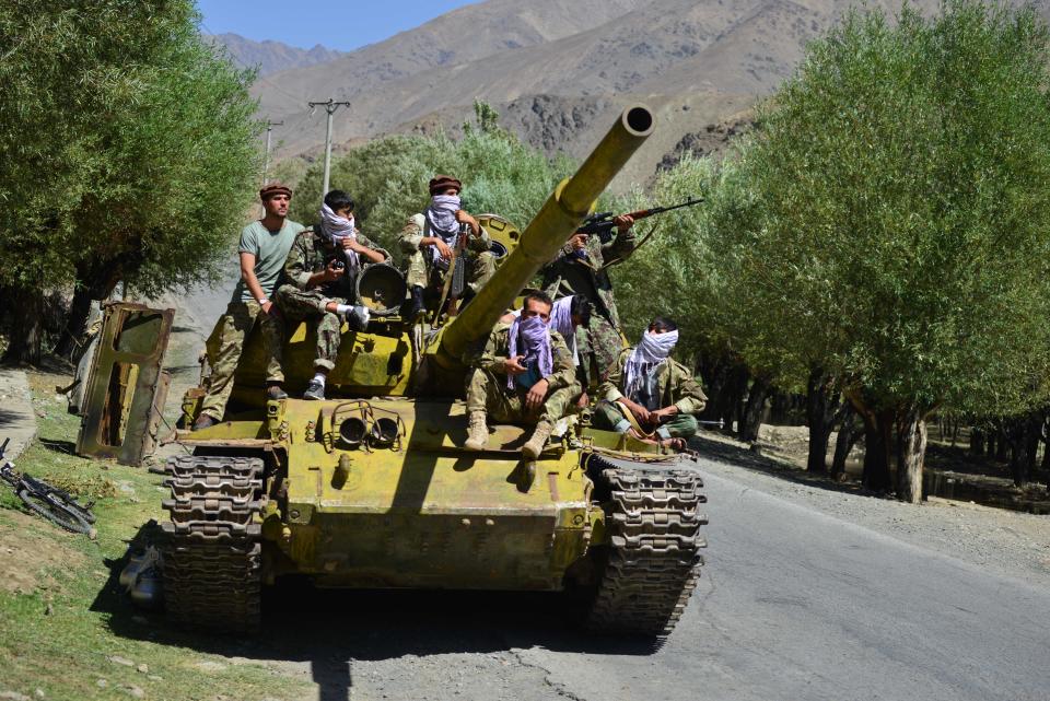 Afghan resistance movement and anti-Taliban uprising forces are pictured on a Soviet-era tank as they are deployed to patrol along a road in the Astana area of Bazarak in Panjshir province on August 27, 2021, as among the pockets of resistance against the Taliban following their takeover of Afghanistan, the biggest is in the Panjshir Valley. (Photo by Ahmad SAHEL ARMAN / AFP) (Photo by AHMAD SAHEL ARMAN/AFP via Getty Images)