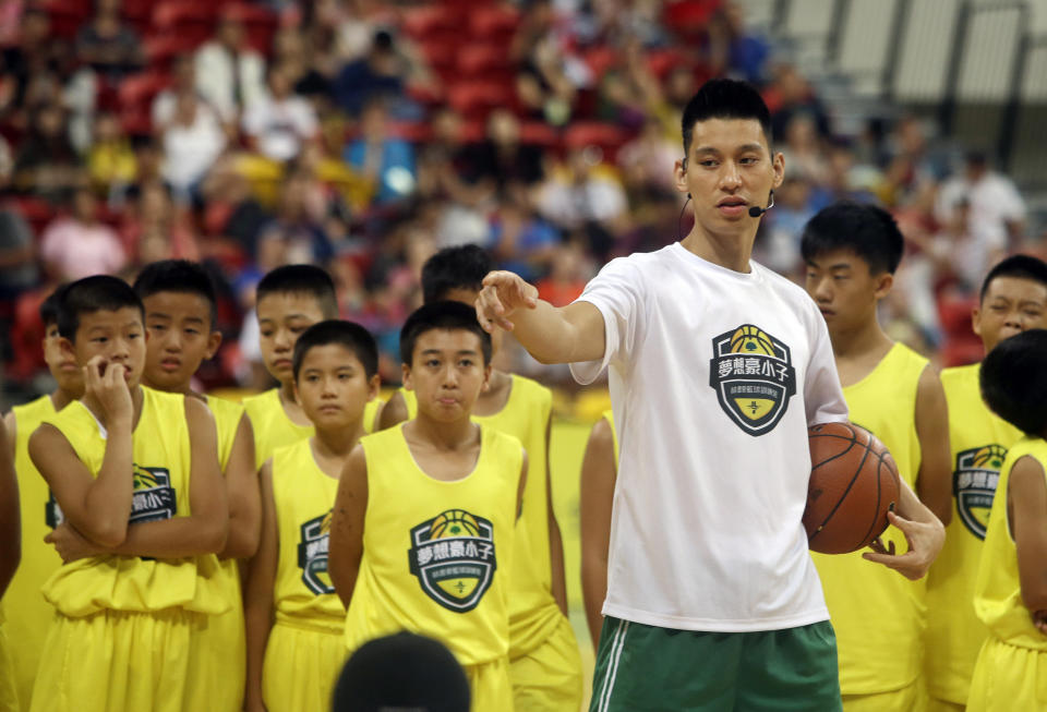 Former Toronto Raptors' Jeremy Lin, currently a free agent, talks to young Taiwanese players during a basketball clinic in Taipei, Taiwan, Saturday, July 27, 2019. Lin is in Taiwan to attend a charity event and basketball clinics for young athletes. (AP Photo/Chiang Ying-ying)