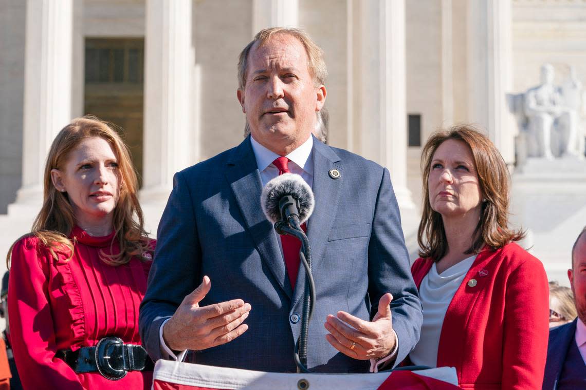 Texas State Rep. Shelby Slawson, left, and Texas State Sen. Angela Paxton, right, listen as Texas Attorney General Ken Paxton, center, speaks to anti-abortion activists at a rally outside the Supreme Court, Monday, Nov. 1, 2021, on Capitol Hill in Washington. (AP Photo/Jacquelyn Martin)