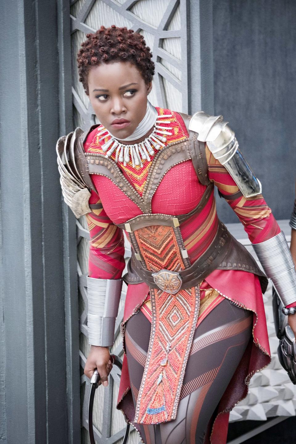 Two characters from Black Panther in intricate warrior costumes, ready for action