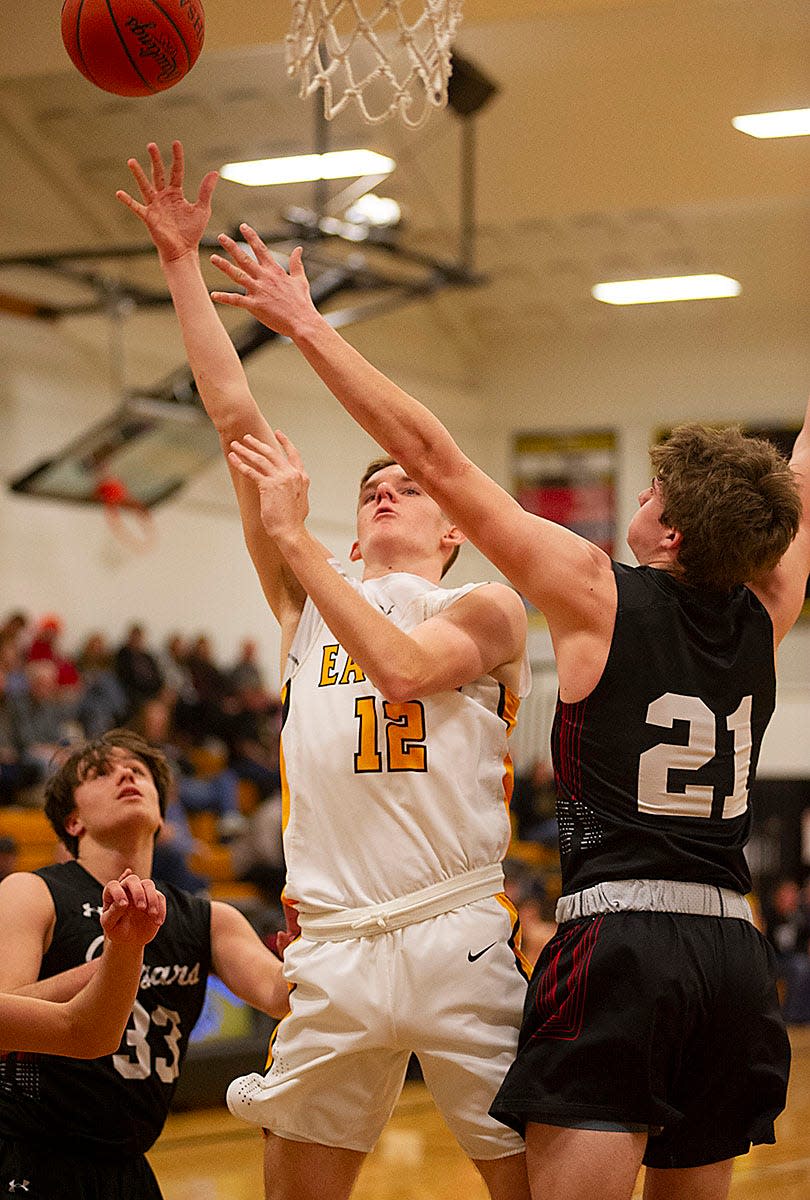 Colonel Crawford's Jacob Maddy shoots around Crestview's Owen Barker.