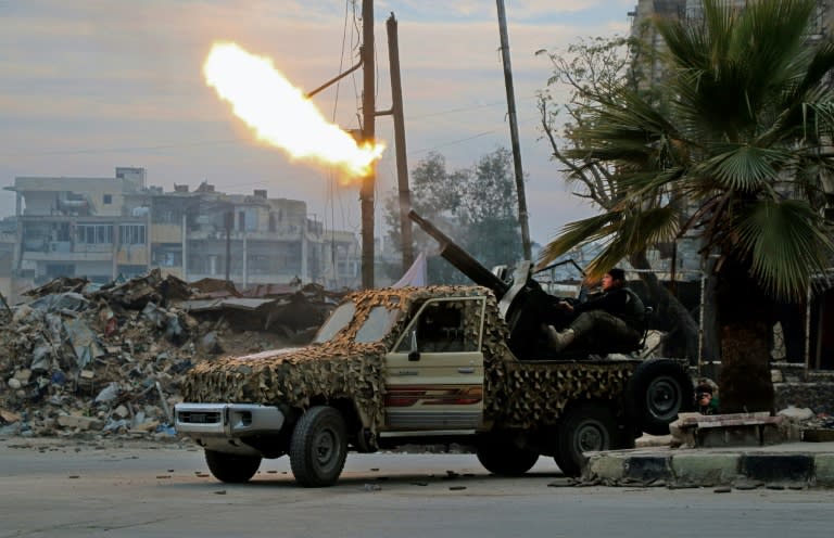 Fighters of the Free Syrian Army, a group which once regrouped Syria's rebel factions but has since broken up, fire an anti-aircraft weapon from a rebel-held area of Aleppo in December 2016