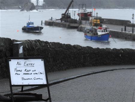 A temporary "No Entry" warning sign stands on an access road to the harbour wall in Tenby, Pembrokeshire, Wales, February 14, 2014. REUTERS/Rebecca Naden