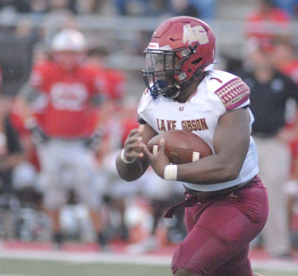 Lake Gibson running back Jaylon Glover looks for an opening in the first quarter against Lake Mary.