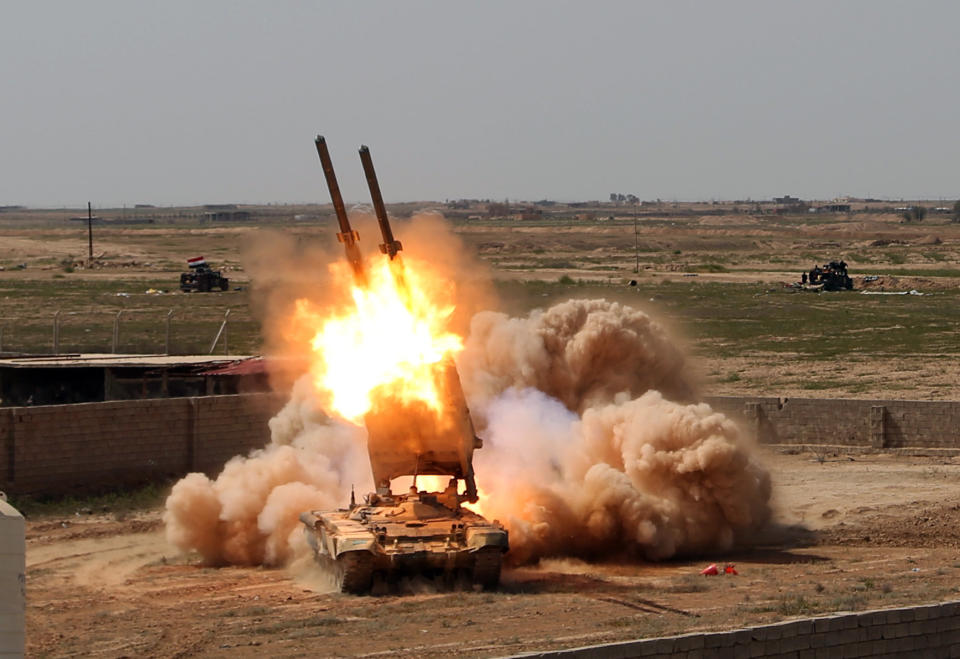 In this Sunday, March 31, 2015 file photo, Iraqi security forces launch rockets against Islamic State extremist positions in Tikrit, 80 miles  north of Baghdad, Iraq. (AP Photo/Khalid Mohammed, File)