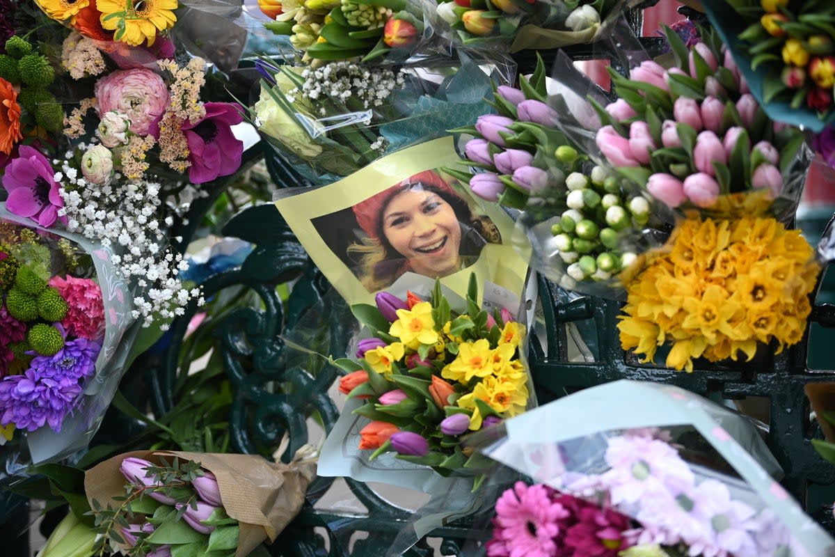 Tributes paid to Sarah Everard at Clapham Common vigil: A photograph of Sarah Everard is left with tributes to her at the bandstand on Clapham Common (Getty Images)
