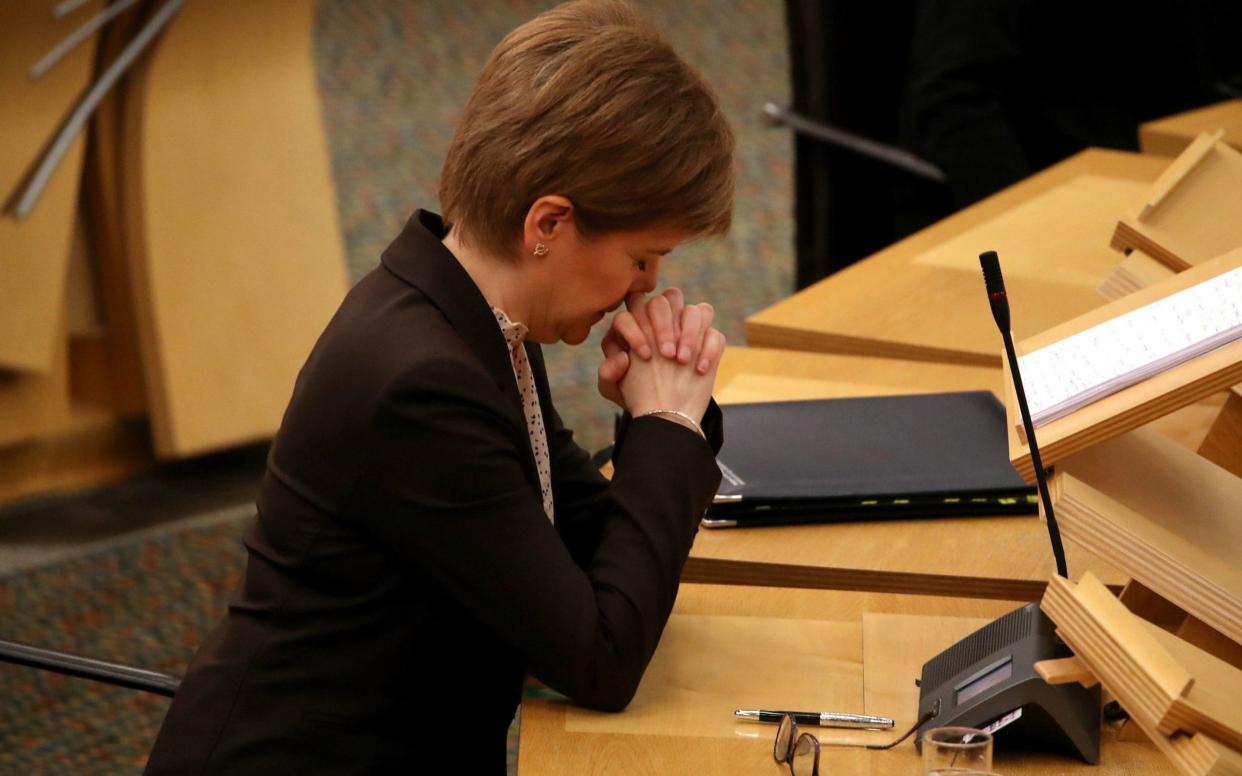 Scottish First Minister Nicola Sturgeon reacts as she delivers a statement at Holyrood, Edinburgh, announcing that Scotland will be placed in lockdown from midnight  - Reuters