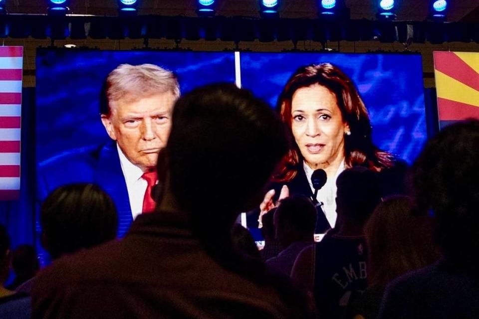 People at the Mesa Convention Center in Mesa, Arizona, watch former President Donald J. Trump and Vice President Kamala Harris debate on Sept. 10, 2024.