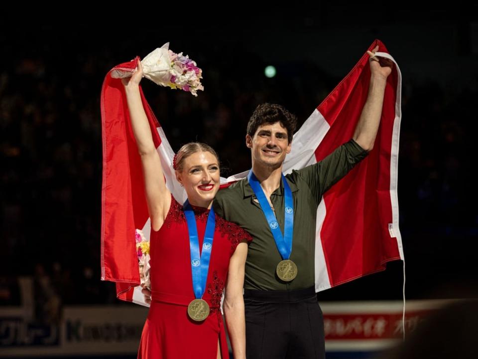 Canada's Piper Gilles and Paul Poirier show off their bronze medals following Saturday's ice dance event at the world figure skating championships in Saitama, Japan. (Philip Fong/AFP via Getty Images - image credit)