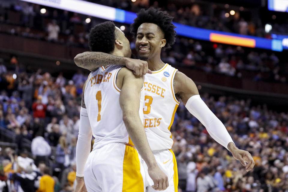 Tennessee's Jordan Bowden, right, and Lamonte Turner (1) celebrate after winning a second round men's college basketball game in the NCAA Tournament against Iowa, Sunday, March 24, 2019, in Columbus, Ohio. (AP Photo/John Minchillo)