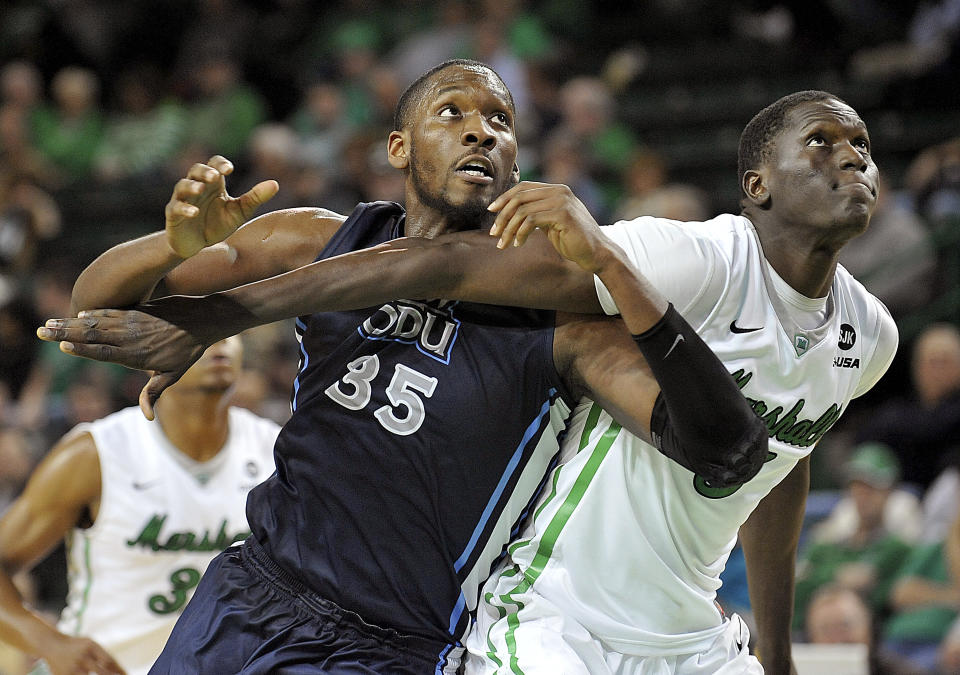 FILE - Old Dominion's Jonathan Arledge (35) battles for position with Marshall's Cheikh Sane, right, during an NCAA college basketball game in Huntington, W.Va., Thursday, Jan. 8, 2015. The Monarchs opened the 2014-15 season 13-1 under coach Jeff Jones and, riding a nine-game winning streak, debuted at No. 25 in the Jan. 5 AP poll. Old Dominion beat Marshall in its next game, but lost to Western Kentucky and dropped out of the AP Top 25 — and has yet to return. (AP Photo/Chris Tilley, File)
