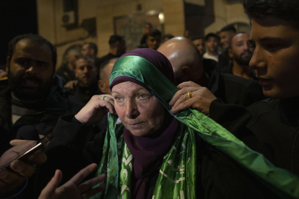 Former Palestinian female prisoner Hanna Barghouti, who was released by the Israeli authorities, wears a Hamas headband while she is received by supporters upon her arrival in the West Bank town of Beitunia, Friday, Nov. 24, 2023. The release came on the first day of a four-day cease-fire deal between Israel and Hamas during which the Gaza militants have pledged to release 50 hostages in exchange for 150 Palestinians imprisoned by Israel. (AP Photo/Nasser Nasser)