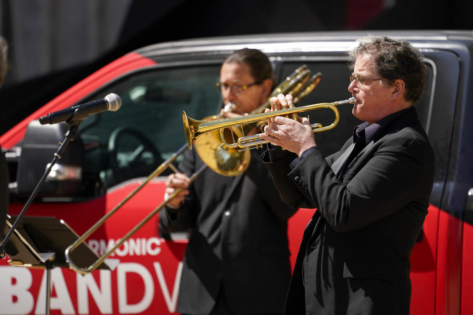 Members of the New York Philharmonic perform on the Lincoln Center campus as part of Restart Stages at Lincoln Center, Wednesday, April 7, 2021, in New York. Members of the New York Philharmonic gave an outdoor concert at Lincoln Center for heath care workers, 13 months after the novel coronavirus pandemic decimated their season. (AP Photo/Mary Altaffer)