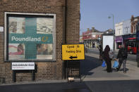 A view of sign directing people to a walk-in coronavirus testing centre on Marlborough Road in Southampton, England, Wednesday, Sept. 16, 2020. The British government plans to ration coronavirus testing, giving priority to health workers and care home staff after widespread reports that people throughout the country were unable to schedule tests. Prime Minister Boris Johnson on Wednesday will face questions about his handling of the COVID-19 pandemic in the House of Commons and before a key committee amid the outcry over the shortage of testing. (Andrew Matthews/PA via AP)
