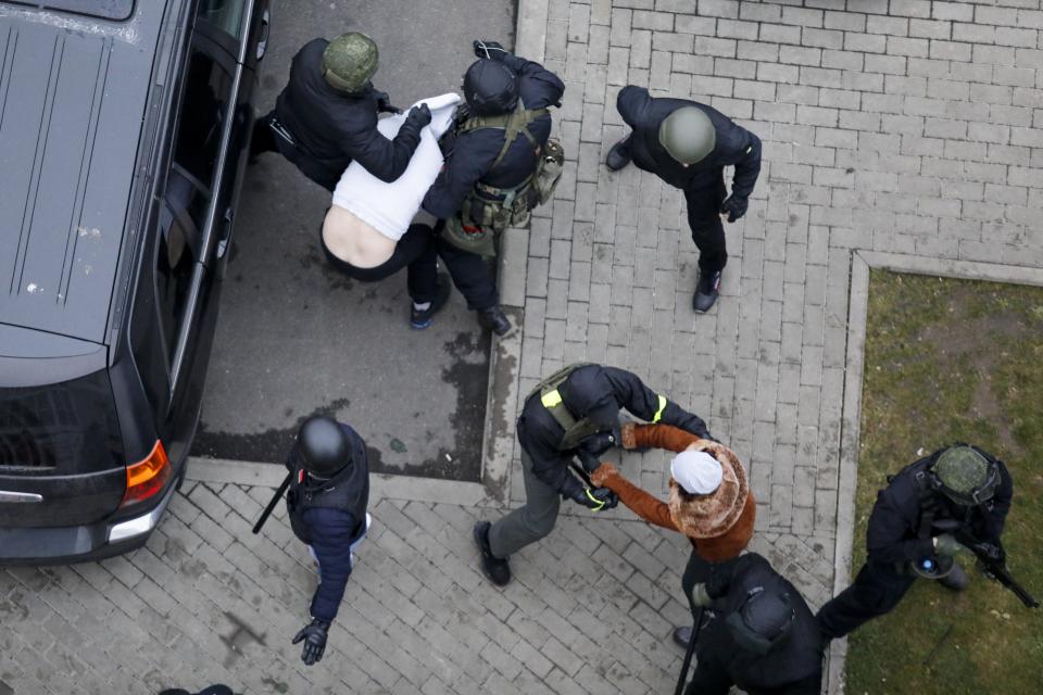 Belarusian riot police detain demonstrators during an opposition rally to protest the official presidential election results in Minsk, Belarus, Sunday, Nov. 15, 2020. Protests have rocked Belarus since the August election that official results say gave Lukashenko a sixth term in office but that opponents and some polls workers claim were manipulated. (AP Photo)