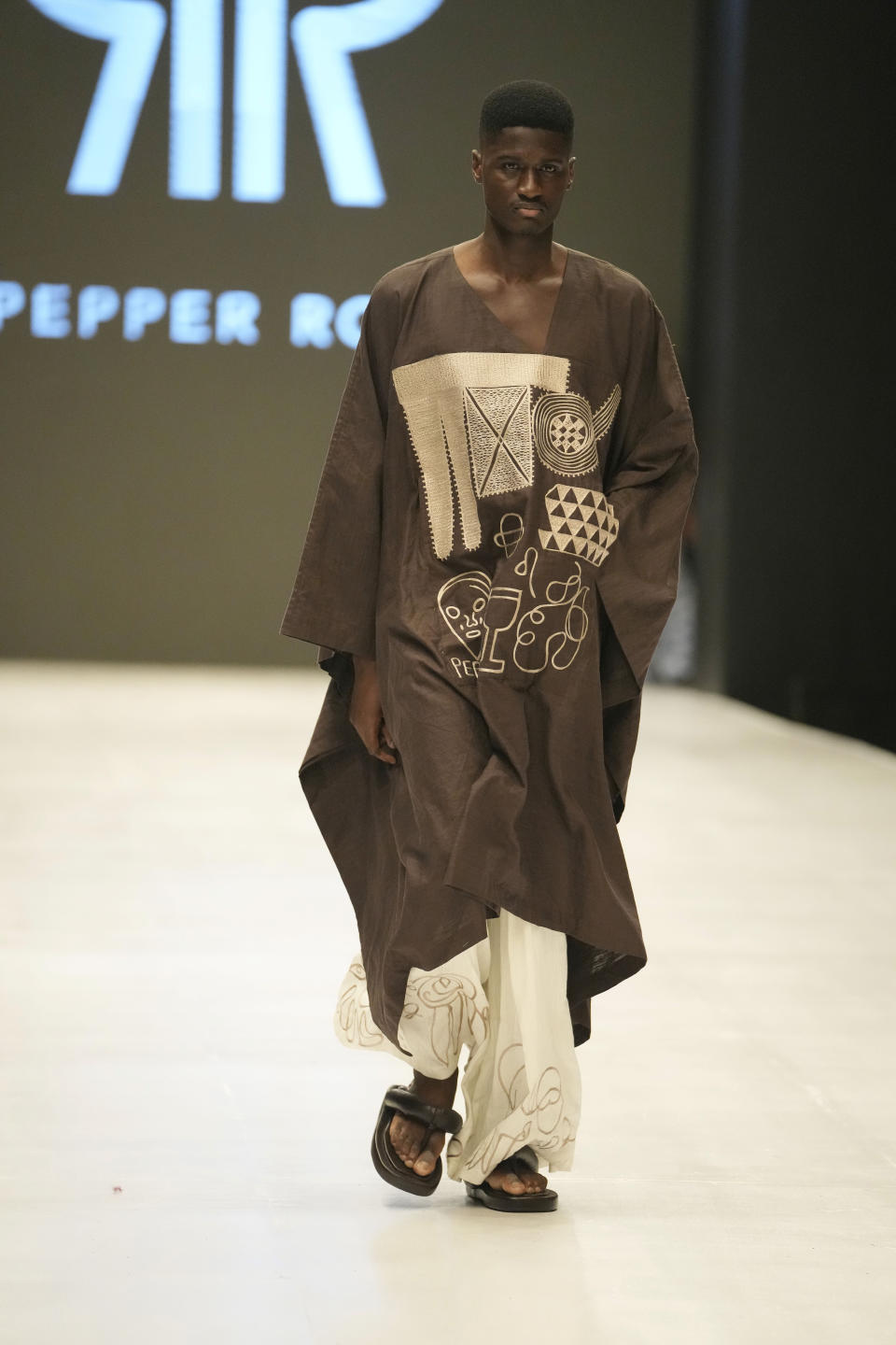 A model wears a creation by Pepper Row during the Lagos Fashion Week in Lagos, Nigeria, Thursday, Oct. 26, 2023. Africa's fashion industry is rapidly growing to meet local and international demands but a lack of adequate investment still limits its full potential, UNESCO said Thursday in its new report released at this year's Lagos Fashion Week show. (AP Photo/Sunday Alamba)