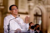 Peru's President Martin Vizcarra addresses the media outside the presidential palace after lawmakers removed him on corruption charges, in Lima