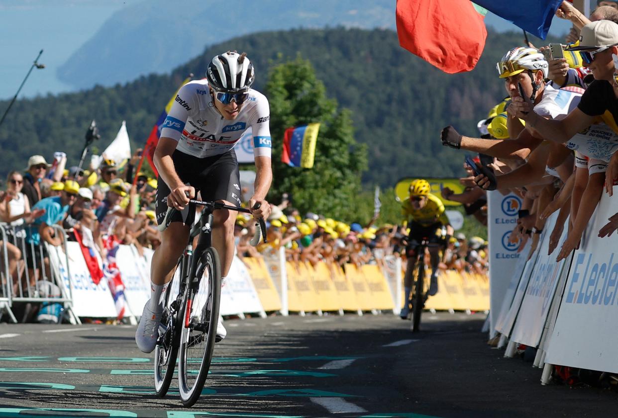 Tadej Pogacar rides away from Jonas Vingegaard at the finish (Reuters)