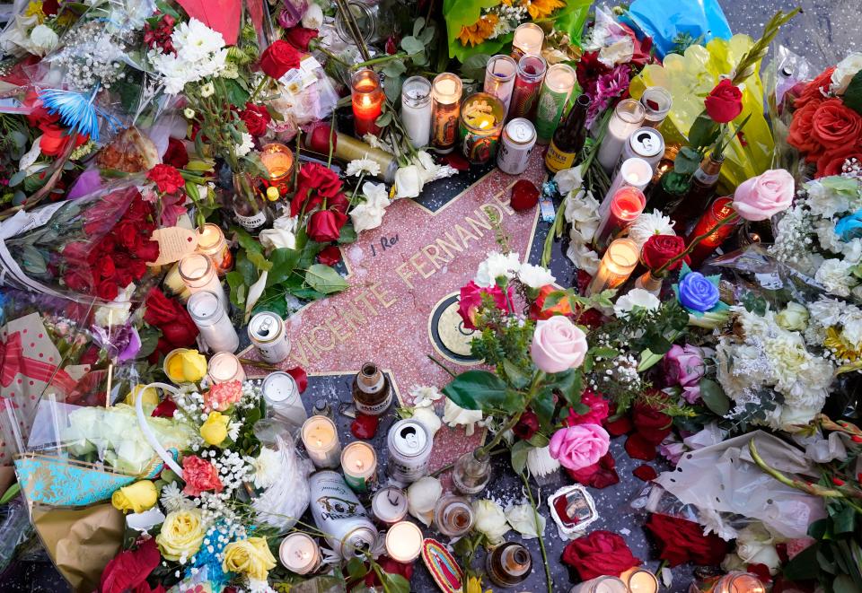 Flowers and candles surround the Hollywood Walk of Fame star of the late Mexican musician Vicente Fernández, Monday, Dec. 13, 2021, in Los Angeles. Fernandez, an iconic and beloved singer of regional Mexican music who was awarded three Grammys and nine Latin Grammys, died on Sunday at 81.