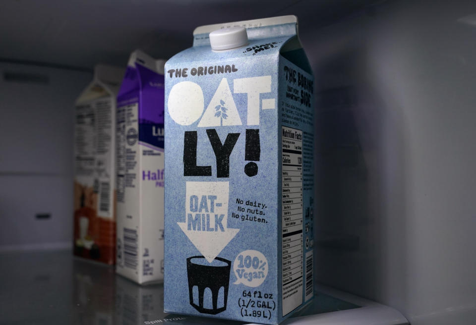 A carton of Oatly oat milk sits in a home refrigerator Tuesday, May 18, 2021, in Bellingham, Wash. Oatly, the world’s largest oat milk company, will raise $1.4 billion in an initial public offering Thursday, May 20 on the Nasdaq stock exchange. (AP Photo/Elaine Thompson)