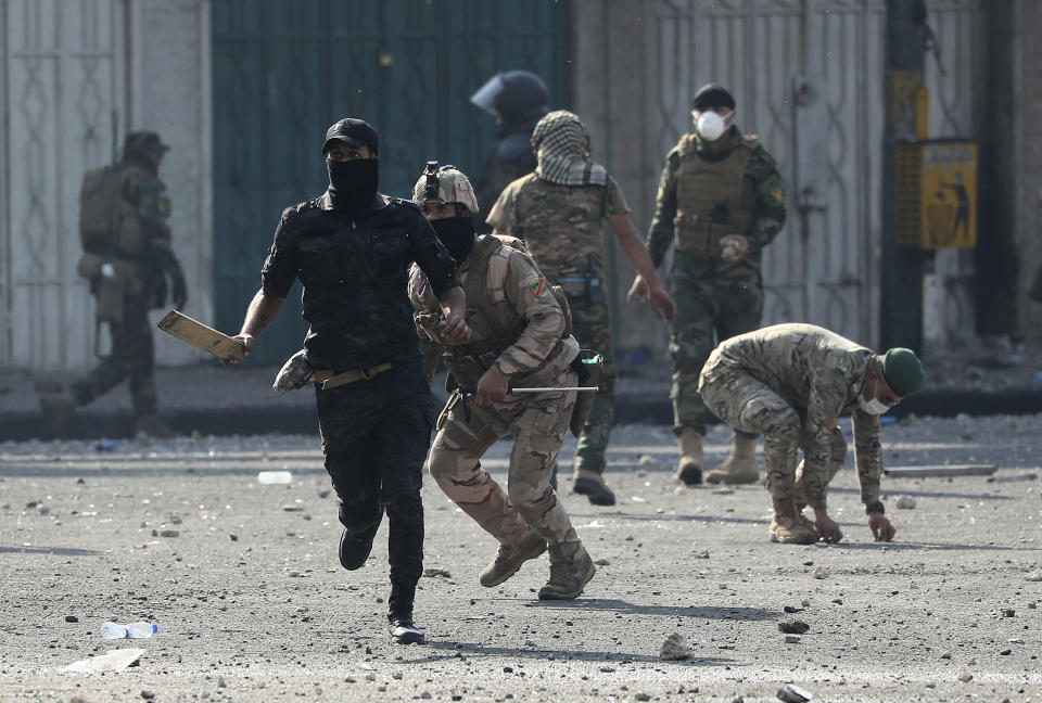 Iraqi security forces try to disperse anti-government protesters during ongoing protests in Baghdad, Iraq, Monday, Nov. 11, 2019. (AP Photo/Hadi Mizban)