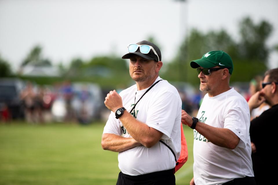 West head coach Ben Hondorp looks to his players on the pitch during the district semis Tuesday, May 31, 2022, at Zeeland East High School.