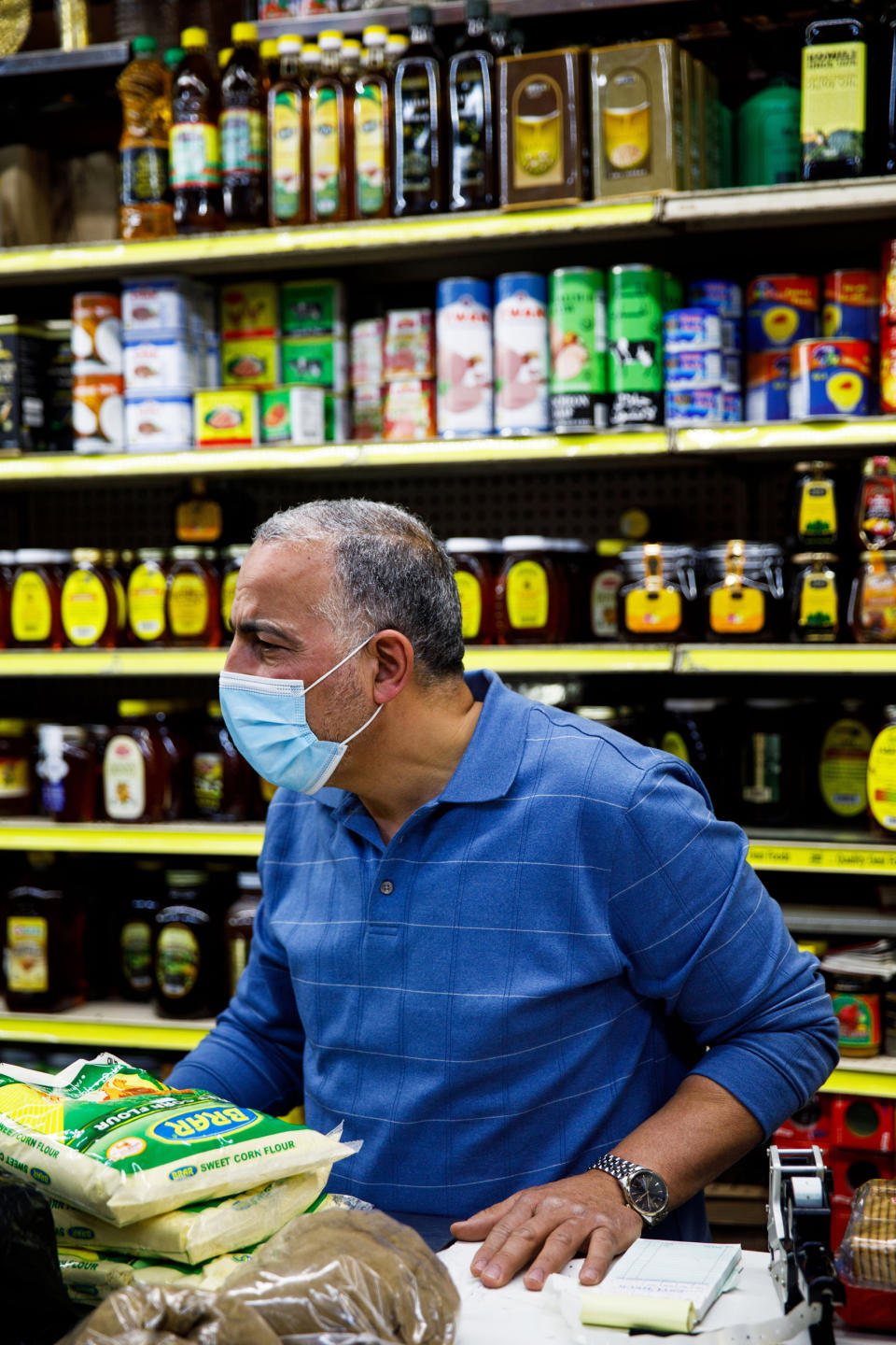 Hamed Nabawy Hamed talks with a customer at his halal grocery store Fertile Crescent in Brooklyn, N.Y., on May 5, 2021. (Julius Constantine Motal / NBC News)