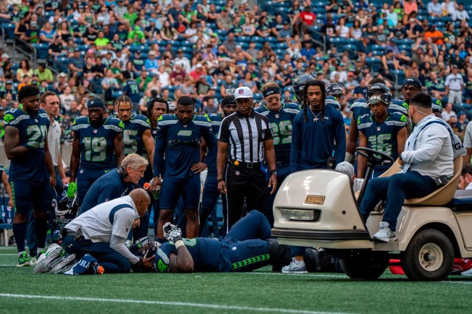 Seahawks left guard Damien Lewis went down at the end of running play early in the second quarter of Seattle’s second preseason game against the Chicago Bears on Aug. 18, 2022.