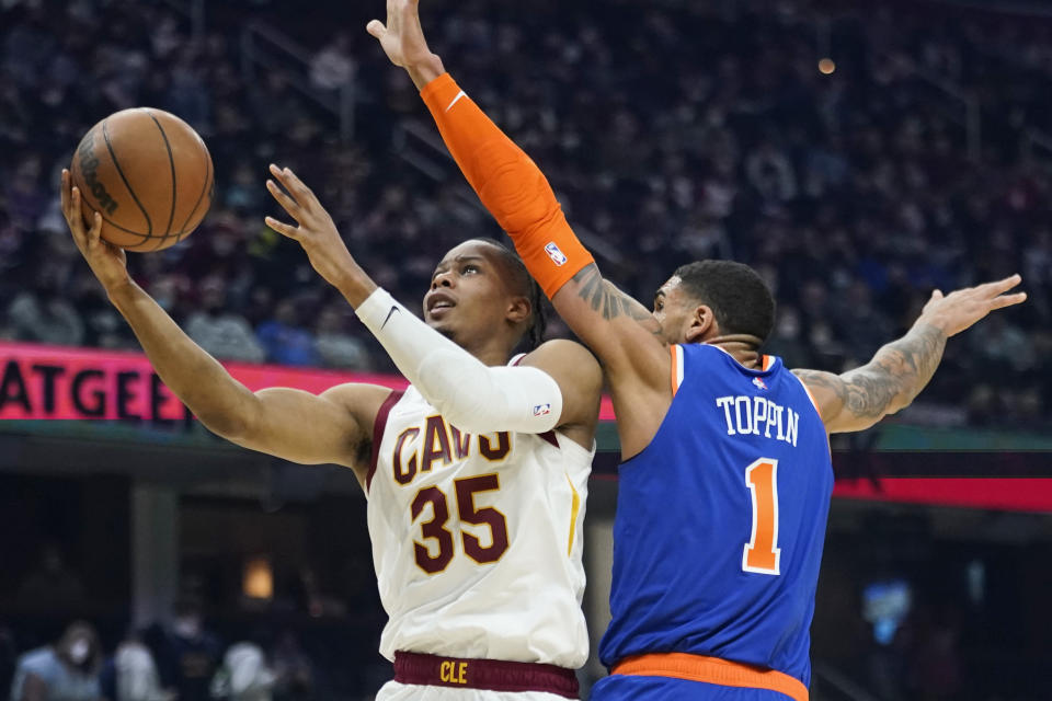 Cleveland Cavaliers' Isaac Okoro (35) drives to the basket against New York Knicks' Obi Toppin (1) in the first half of an NBA basketball game, Monday, Jan. 24, 2022, in Cleveland. (AP Photo/Tony Dejak)