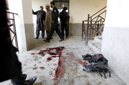 Blood stains and flak jackets used by attackers remain in the hallway of a dormitory where a militant attack took place, at Bacha Khan University in Charsadda, Pakistan January 20, 2016. REUTERS/Caren Firouz