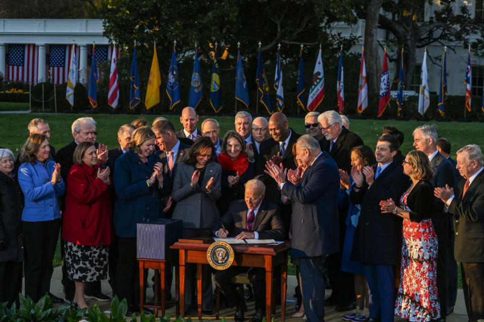 <div class="inline-image__caption"><p>President Joe Biden signs the Infrastructure Investment and Jobs Act as he is surrounded by lawmakers and members of his Cabinet during a ceremony on the South Lawn at the White House on November 15, 2021 in Washington, DC.</p></div> <div class="inline-image__credit">Kenny Holston/Getty Images</div>