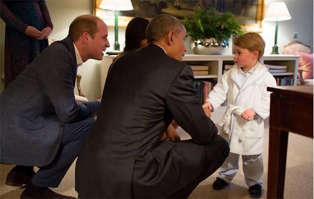 Prince George greets Barack Obama.