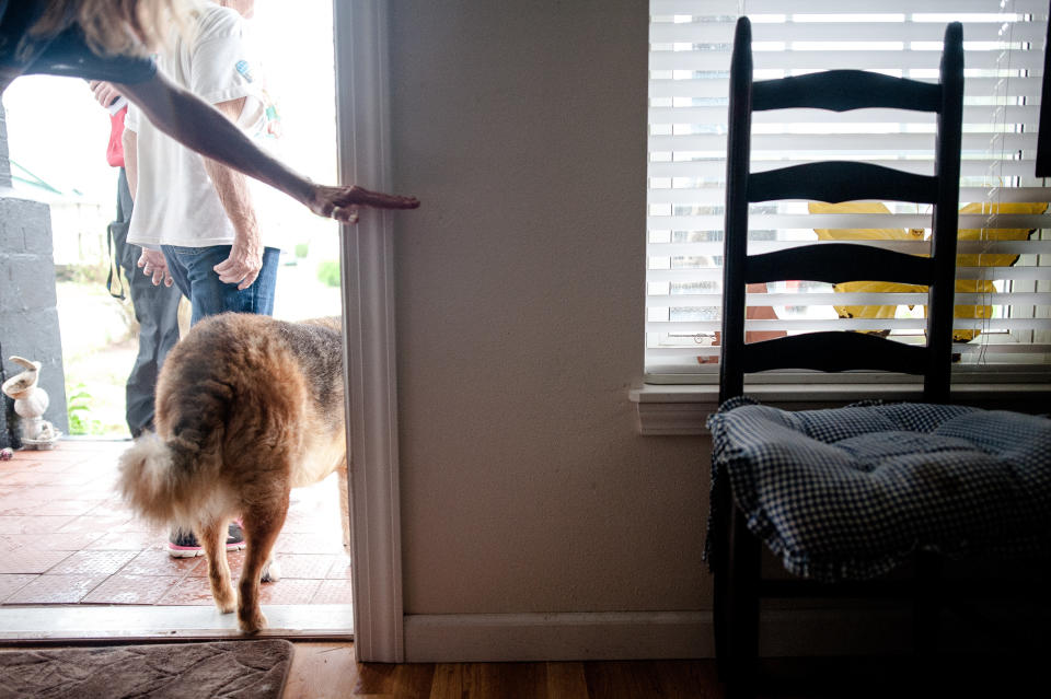 Allen places her hand at the level where floodwaters reached in her home in Lumberton during Hurricane Matthew in 2016.