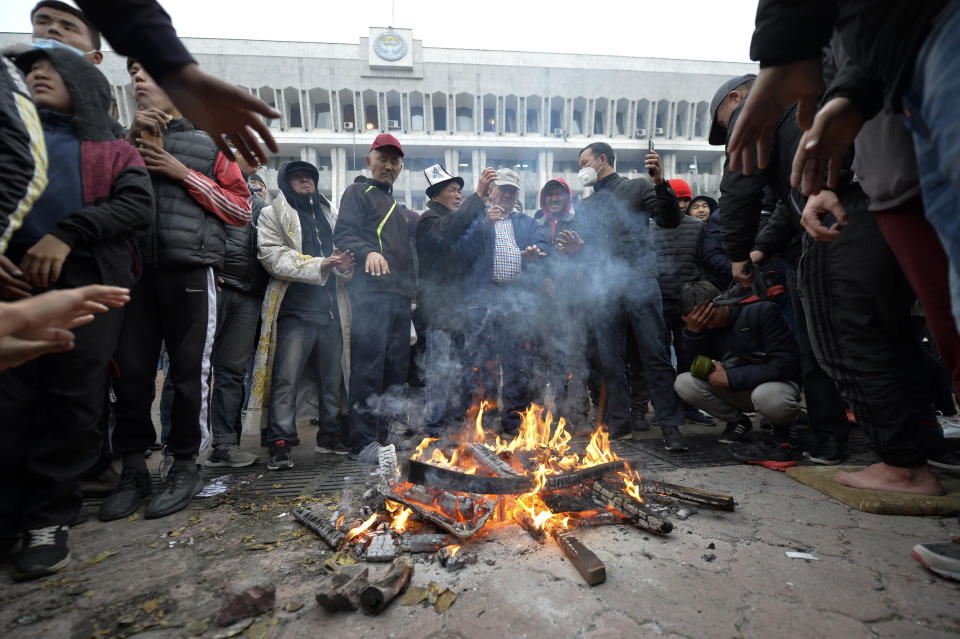 Protesters gather in front of the Kyrgyz government headquarters on the central square in Bishkek, Kyrgyzstan, Tuesday, Oct. 6, 2020. Protesters have clashed with police in Kyrgyzstan's capital during a demonstration against the results of a parliamentary election. Early results in the election gave the majority of votes to two parties with ties to the ruling elites amid allegations of vote buying. (AP Photo/Vladimir Voronin)