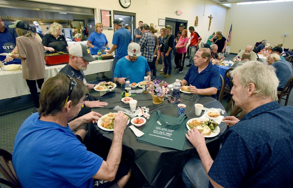 Clients are shown at Friday's God Works community meal at St. Mary Catholic Church's Parish Life Center. One of Friday's diners had God Works' 1 millionth meal.