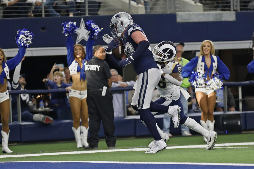 Dallas Cowboys tight end Jason Witten, left, avoids a tackle by Los Angeles Rams defensive back Marqui Christian, right, and carries in for a touchdown in the first half of an NFL football game in Arlington, Texas, Sunday, Dec. 15, 2019. (AP Photo/Roger Steinman)