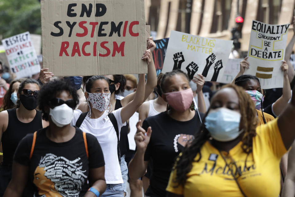 FILE - In this June 19, 2020, file photo, people demonstrate in Chicago, to mark Juneteenth. A national coalition of labor unions, along with racial and social justice organizations, will stage a mass walkout from work July 20, as part of an ongoing reckoning on systemic racism and police brutality in the U.S. (AP Photo/Nam Y. Huh, File)