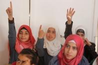 Syrian refugee girls gesture as they sit inside a classroom at a school for Syrian refugee girls, built by the Lebanese non-profit Kayany Foundation in Bar Elias town, in the Bekaa valley, Lebanon October 19, 2017. Picture taken October 19, 2017. REUTERS/Aziz Taher