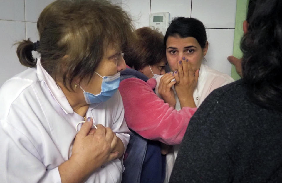 Medical workers react hiding in a basement of a hospital during shelling by Azerbaijan's artillery in Stepanakert, the separatist region of Nagorno-Karabakh, Wednesday, Oct. 28, 2020. Nagorno-Karabakh officials said Azerbaijani forces hit Stepanakert, the region's capital, and the nearby town of Shushi with the Smerch long-range multiple rocket systems, killing one civilian and wounding two more. (AP Photo)