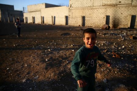 Boys play in the rebel held besieged Douma neighbourhood of Damascus, Syria January 3, 2017. REUTERS/Bassam Khabieh