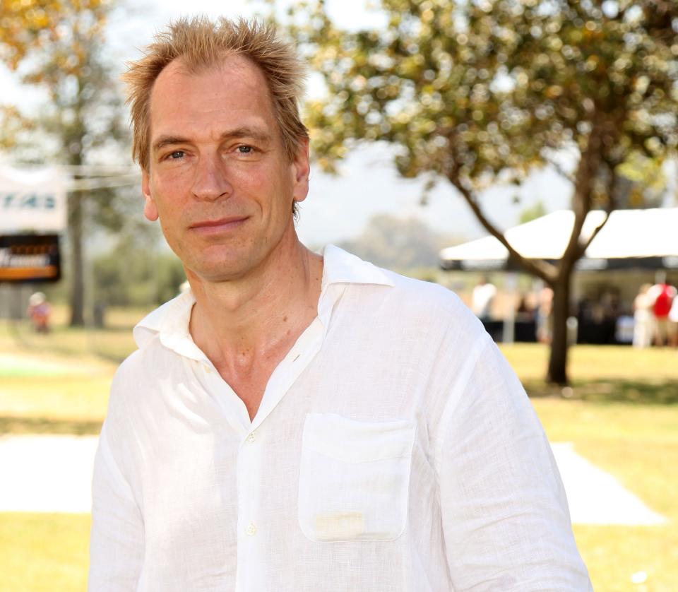 Julian Sands in a white shirt