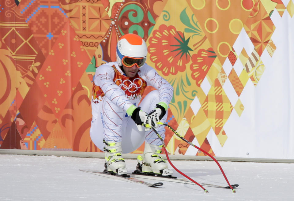 United States' Bode Miller sits on his skis after finishing the men's downhill at the Sochi 2014 Winter Olympics, Sunday, Feb. 9, 2014, in Krasnaya Polyana, Russia. (AP Photo/Gero Breloer)