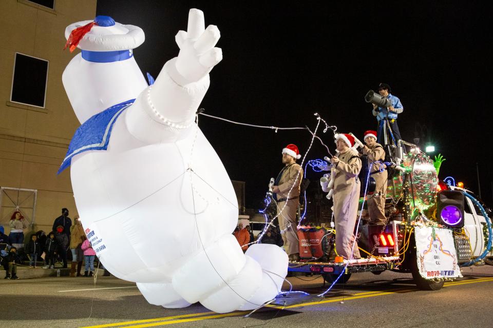 Parade participants dressed up as the Ghostbusters pretend to take down the Stay Puft Marshmallow Man from the Roto-Rooter float during the Jackson Downtown Christmas Parade on Monday, December 12, 2022, in Jackson, Tenn. 