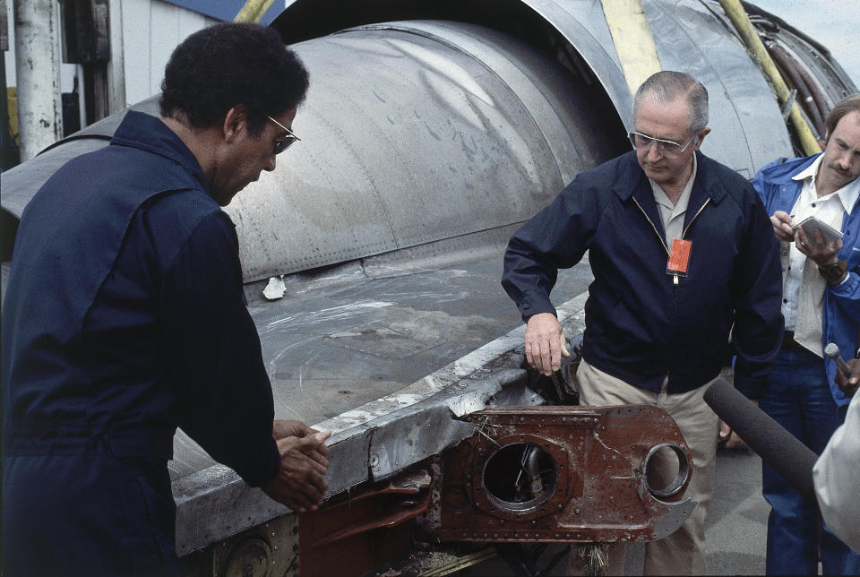 FILE - In this May 26, 1979 photo, William Schaefer of American Airlines, right, and Elwood Driver of the National Transportation Safety Board, left, examine the engine that fell off the DC-10 in Chicago, Ill., Decades later, the crash of American Airlines Flight 191 moments after it took off from O'Hare International Airport remains the deadliest aviation accident in U.S. history. The DC-10 was destined for Los Angeles when it lost one of its engines May 25, 1979, killing what investigators later determined were 273 people _ all 271 people aboard the jetliner and two people on the ground. (AP Photo/Fred Jewell File)