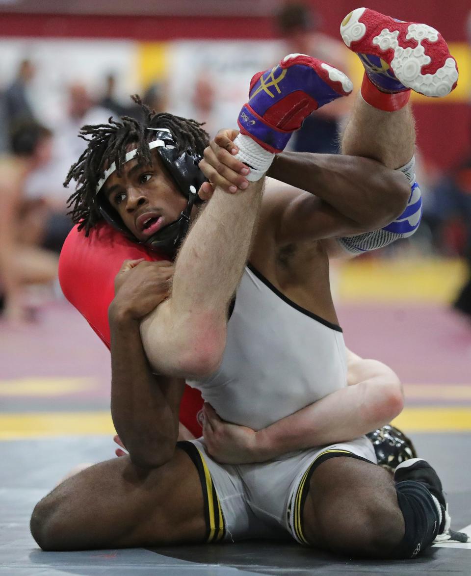 Charles Curtis of Perry wrestles Colin Kacena of Lake Highland Prep in a 138-pound match in Walsh Jesuit's Ironman Wrestling Tournament, Friday, Dec. 8, 2023.