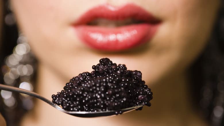 Woman eating caviar