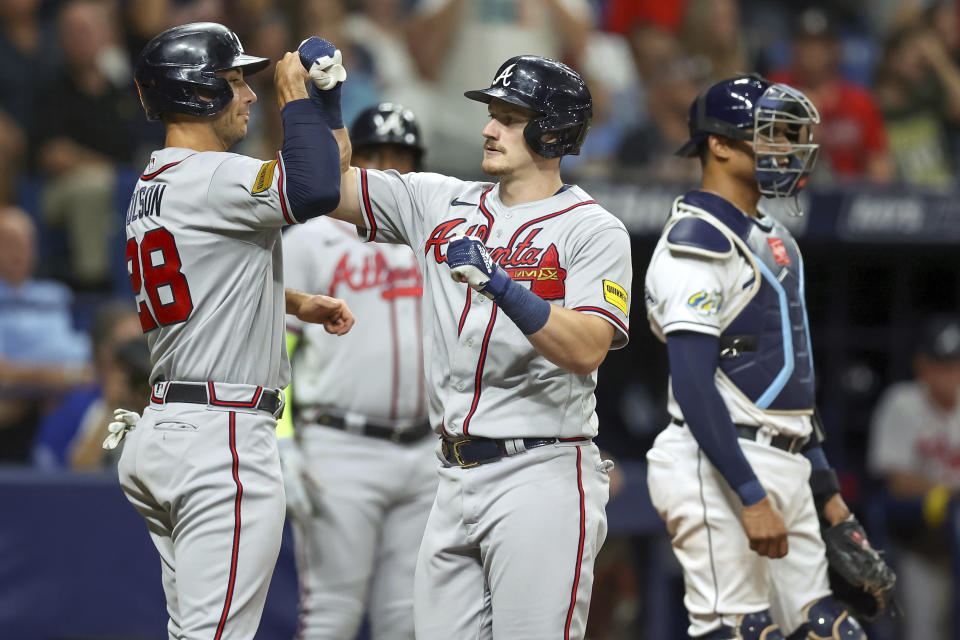 Atlanta Braves' Sean Murphy, center, celebrates his two-run home run with Matt Olson, left, as Tampa Bay Rays catcher Christian Bethancourt stands nearby during the fourth inning of a baseball game Friday, July 7, 2023, in St. Petersburg, Fla. (AP Photo/Mike Carlson)