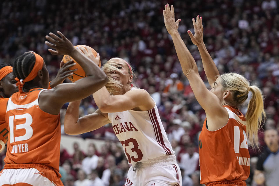 Indiana's Sydney Parrish (33) shoots against Miami's Lashae Dwyer (13) and Haley Cavinder (14) during the first half of a second-round college basketball game in the women's NCAA Tournament Monday, March 20, 2023, in Bloomington, Ind. (AP Photo/Darron Cummings)