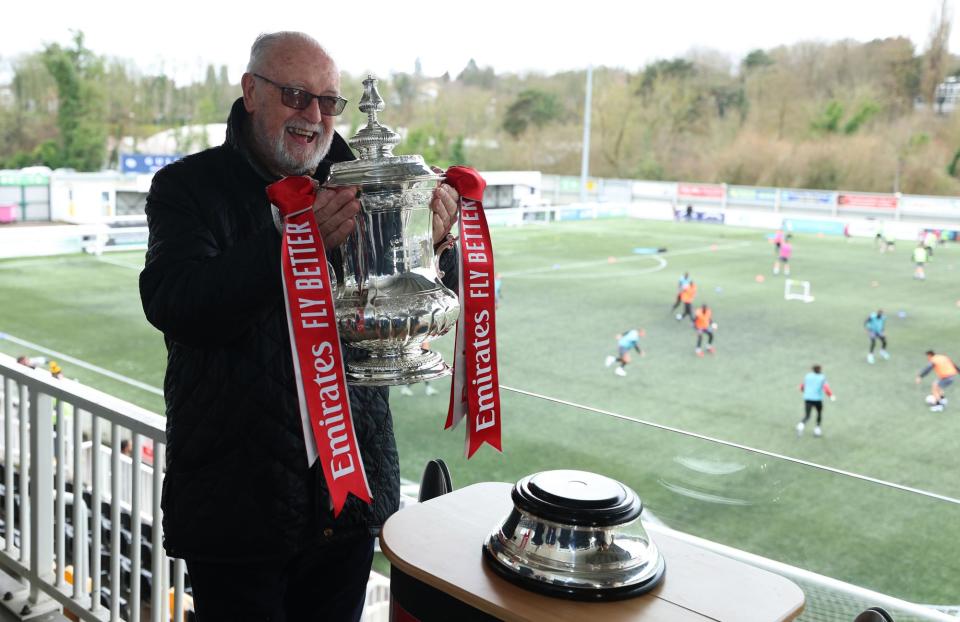 <span>Maidstone chief executive and director of football Bill Williams lifts the FA Cup at their stadium this week.</span><span>Photograph: Richard Pelham/The FA/Getty Images</span>